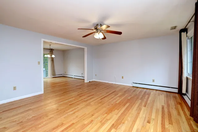 wooden floor in an empty room with a window