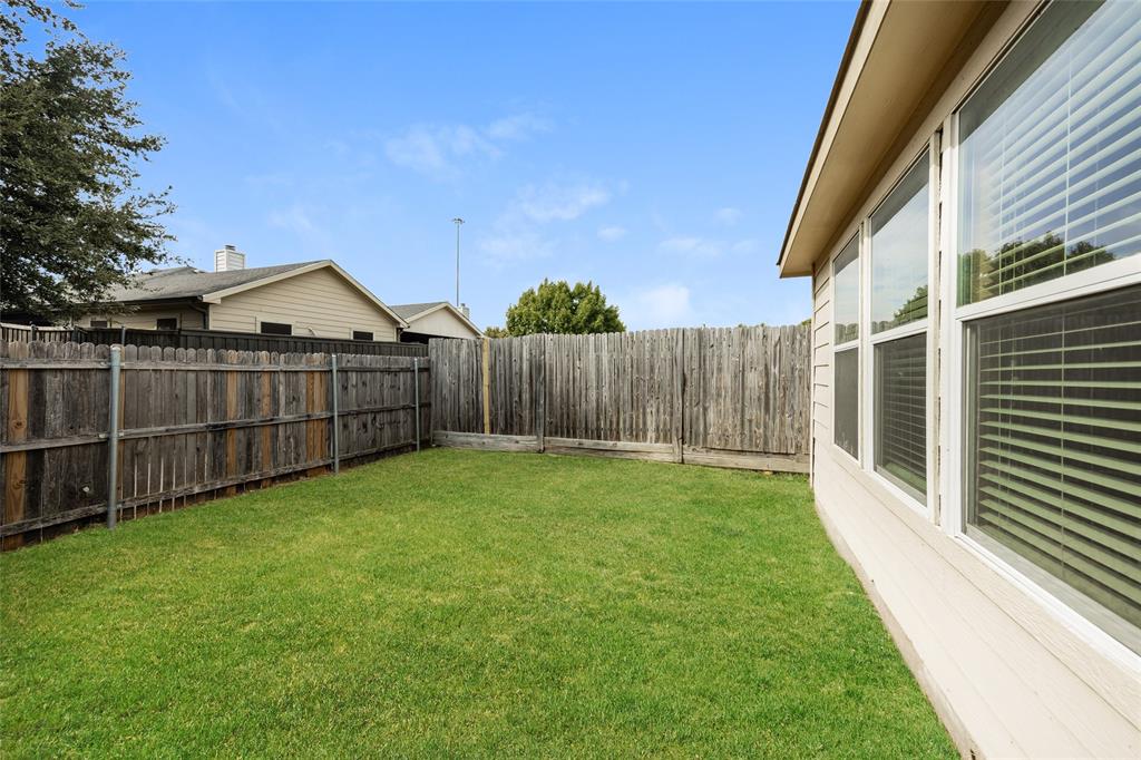 112 Bushel Lane Dallas, TX 75241 - Photo 15 of 16 a view of backyard with wooden fence and large trees