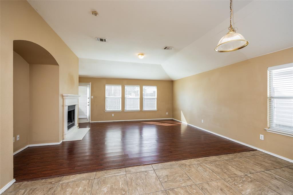 112 Bushel Lane Dallas, TX 75241 - Photo 3 of 16 an empty room with wooden floor and windows