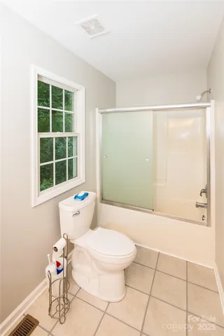 a white toilet sitting next to a bathroom sink