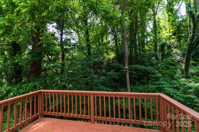a view of balcony with deck and trees