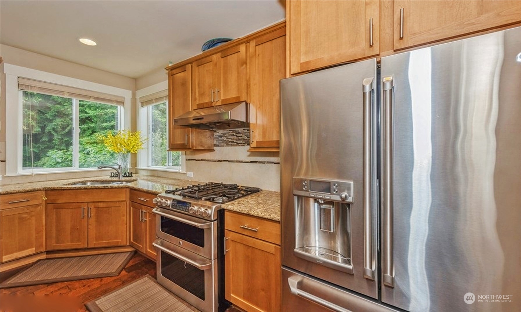 6219 Southeast 2nd Street Renton, WA 98059 - Photo 12 of 40 a kitchen with stainless steel appliances granite countertop a refrigerator and a stove