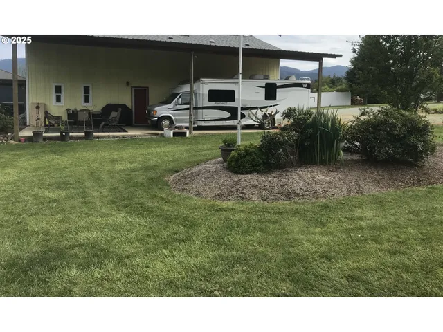 a backyard of a house with table and chairs