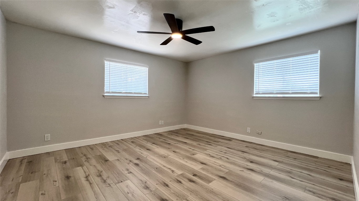11103 Renel Drive, Unit A Austin, TX 78758 - Photo 4 of 7 wooden floor in an empty room with a window