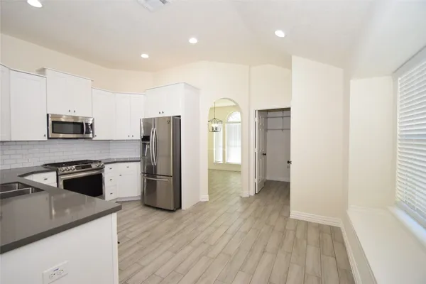 a kitchen with a refrigerator and a sink