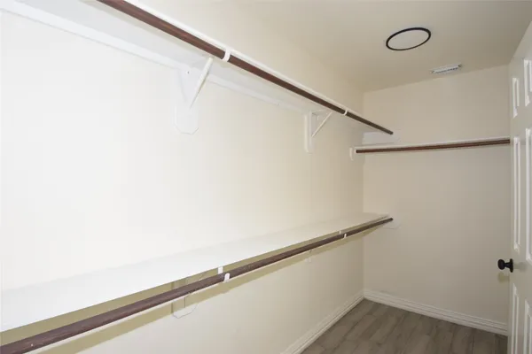a bathroom with a sink a granite tub shower and mirror