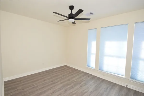 a view of a room with wooden floor