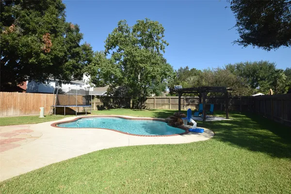 a view of a patio with a table chairs and a backyard