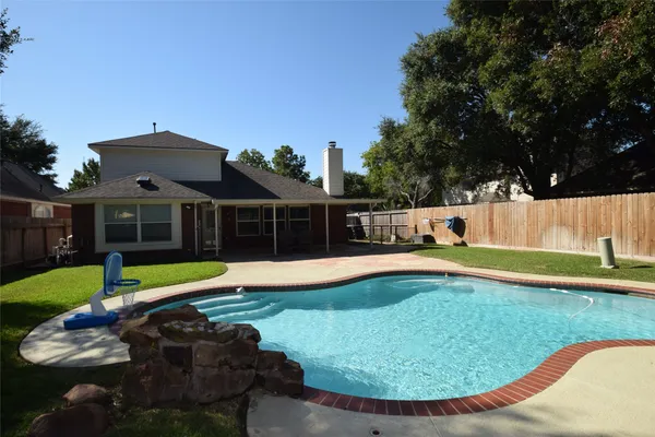 a view of backyard with plants and tub