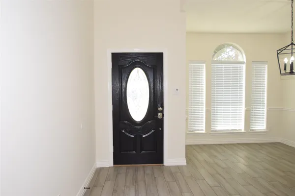 a view of a livingroom with wooden floor and window