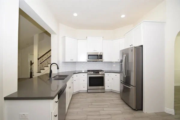 a kitchen with a sink a stove and refrigerator