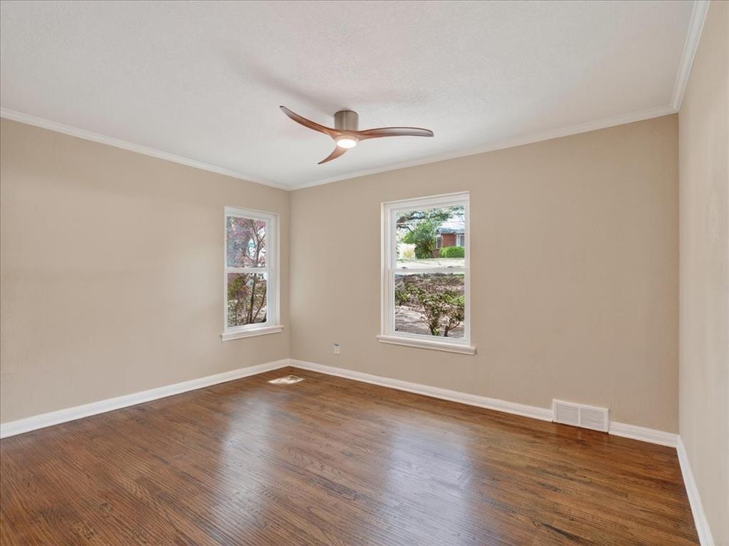 3863 Clayton Road East Fort Worth, TX 76116 - Photo 28 of 39 a view of an empty room with wooden floor and a window