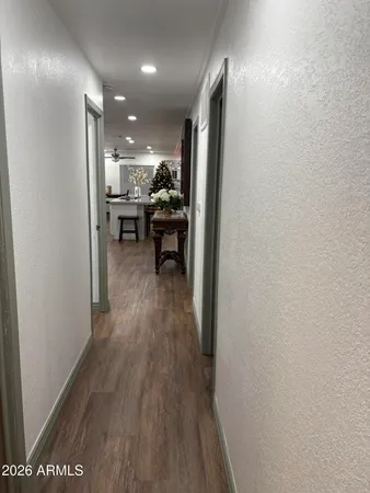 a view of a hallway and wooden floor