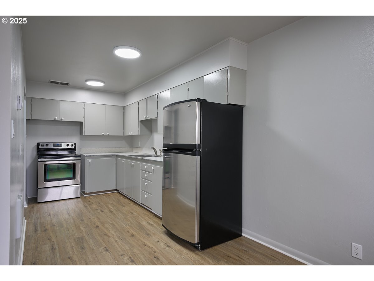 304 East Park Street Enterprise, OR 97828 - Photo 6 of 20 a kitchen with a refrigerator and a stove top oven