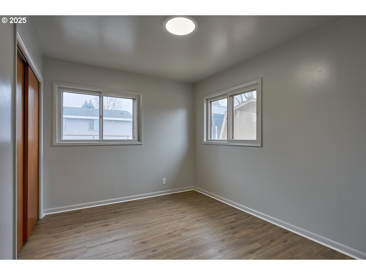304 East Park Street Enterprise, OR 97828 - Photo 8 of 20 an empty room with wooden floor and windows