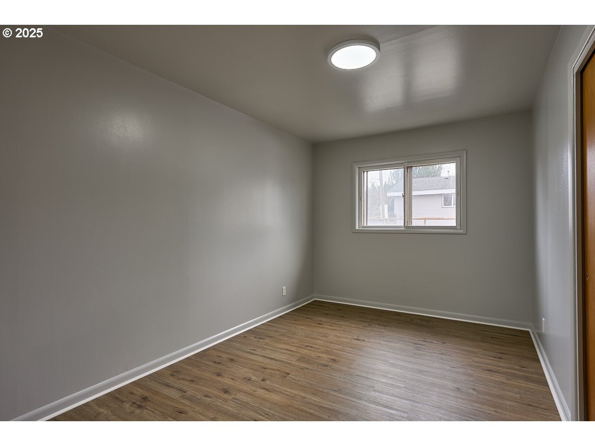 304 East Park Street Enterprise, OR 97828 - Photo 10 of 20 a view of an empty room with wooden floor and a window