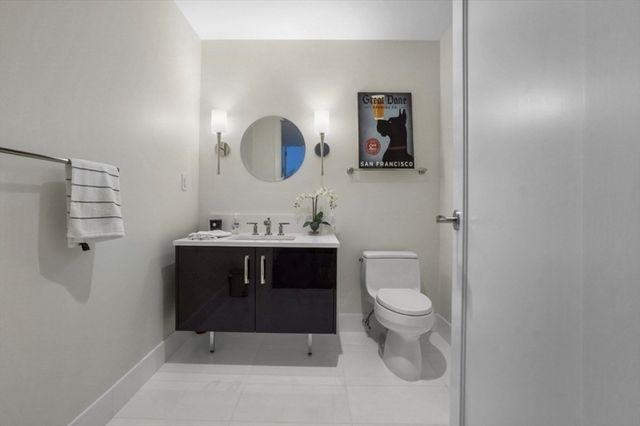 a bathroom with a sink a toilet and mirror