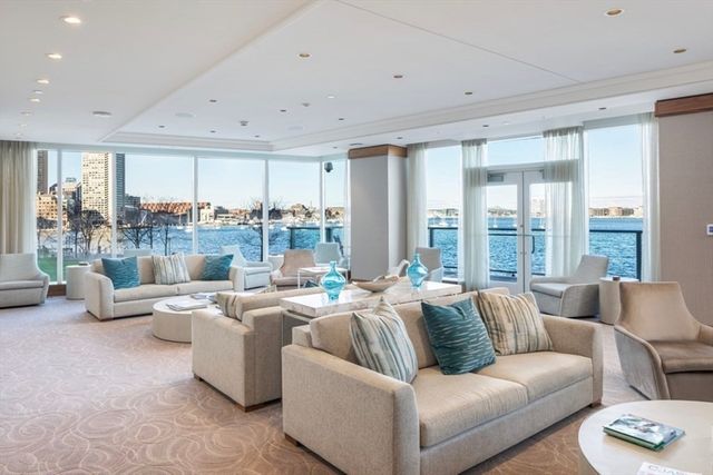 a living room with furniture and large windows