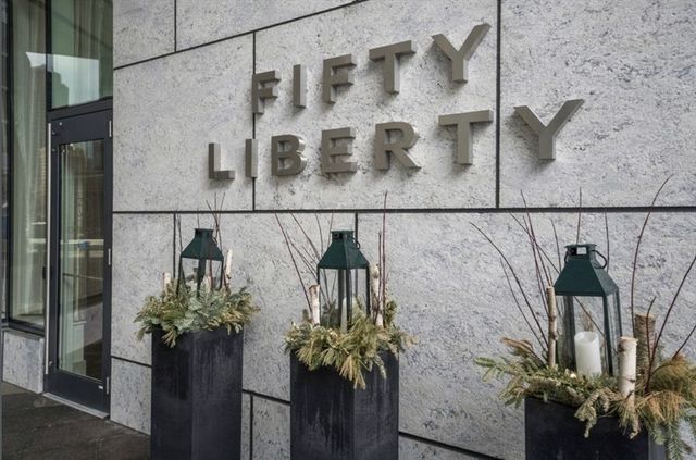 a vase of flowers sitting on a floor