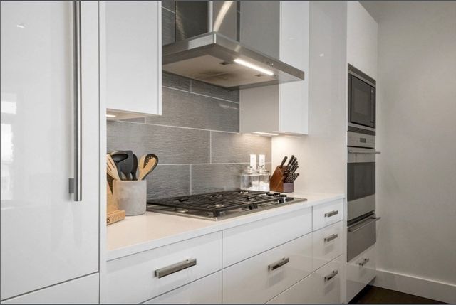 a kitchen with a stove and cabinets