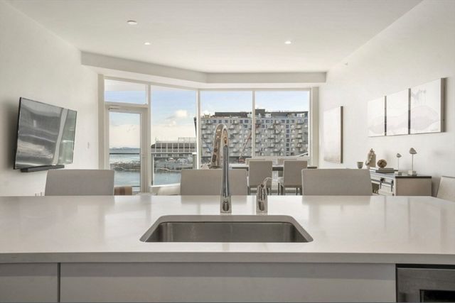 a kitchen with a sink and a large window