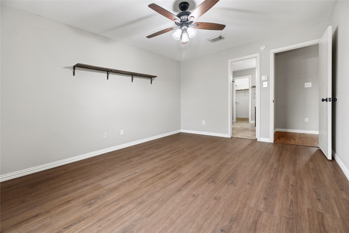 24006 Lazy Kay Lane Hockley, TX 77447 - Photo 11 of 21 a view of a room with wooden floor and a ceiling fan