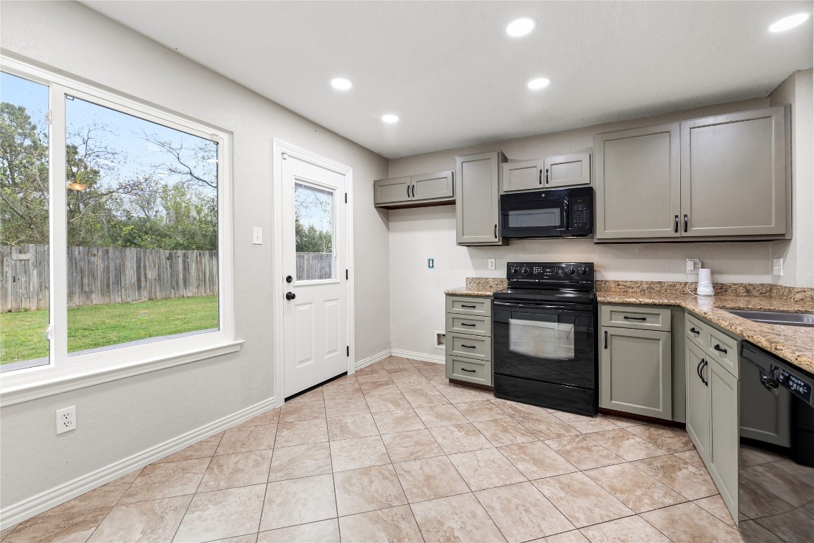24006 Lazy Kay Lane Hockley, TX 77447 - Photo 7 of 21 a kitchen with stainless steel appliances granite countertop a stove top oven a sink dishwasher a refrigerator and a microwave