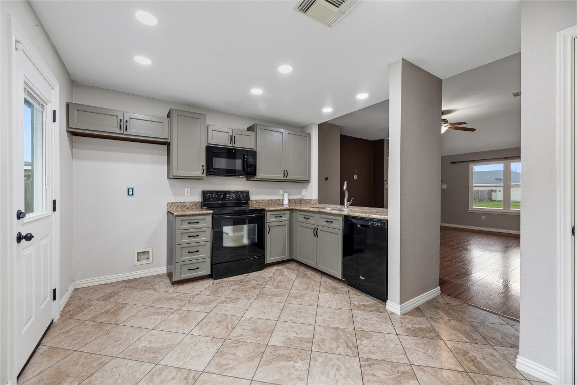 24006 Lazy Kay Lane Hockley, TX 77447 - Photo 8 of 21 a kitchen with stainless steel appliances granite countertop a refrigerator and a stove top oven