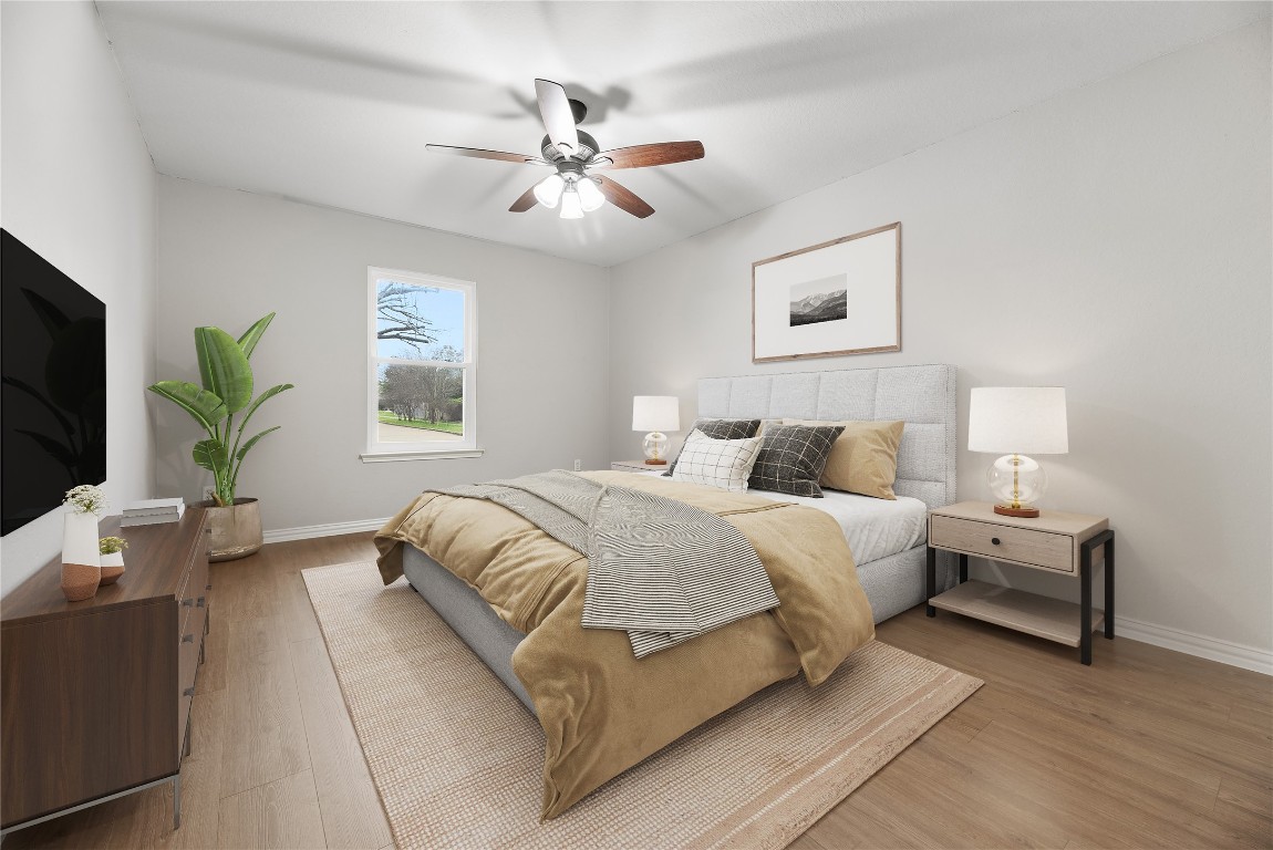 24006 Lazy Kay Lane Hockley, TX 77447 - Photo 10 of 21 a spacious bedroom with a bed and a chandelier