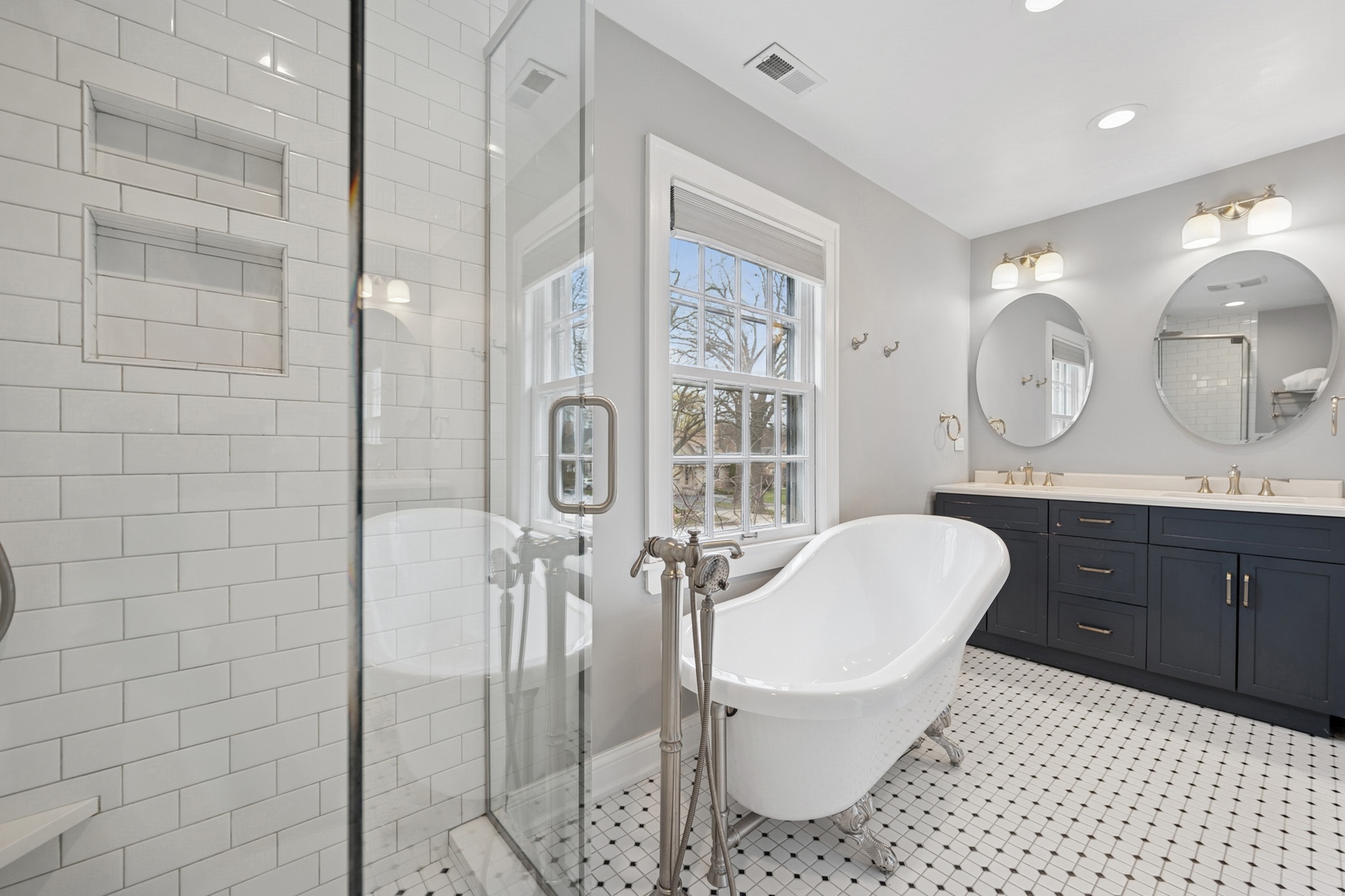 2145 Chestnut Avenue Wilmette, IL 60091 - Photo 21 of 38 a spacious bathroom with a double vanity sink toilet mirror and shower