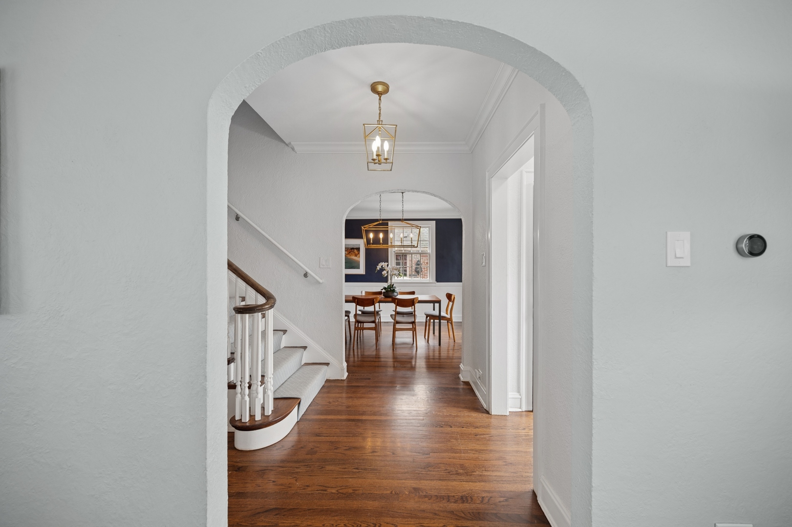 2145 Chestnut Avenue Wilmette, IL 60091 - Photo 9 of 38 a view of a hallway with wooden floor table and chairs