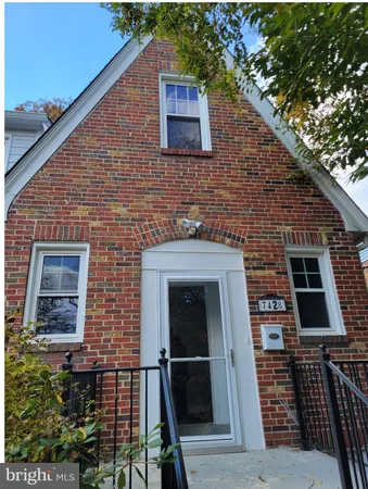 a brick house with a door and a yard