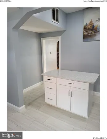 a kitchen with cabinets and stainless steel appliances