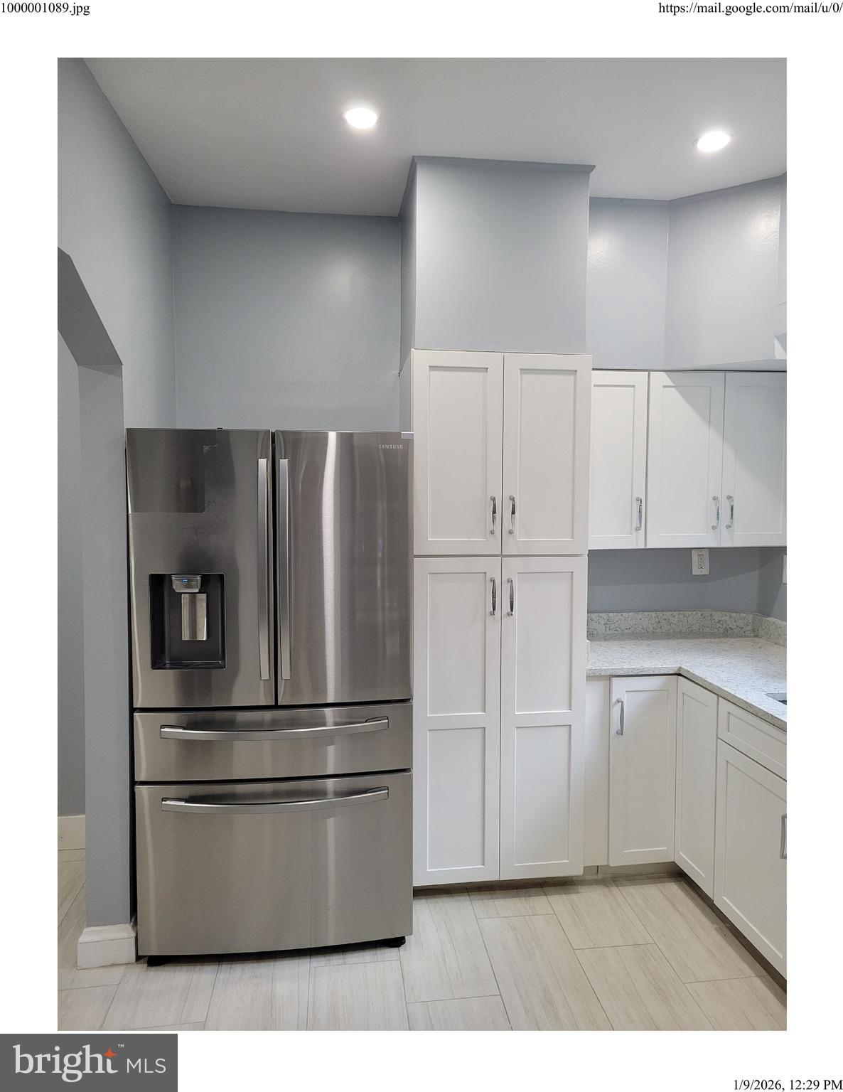 7428 Piney Branch Road Takoma Park, MD 20912 - Photo 6 of 7 a kitchen with cabinets and stainless steel appliances