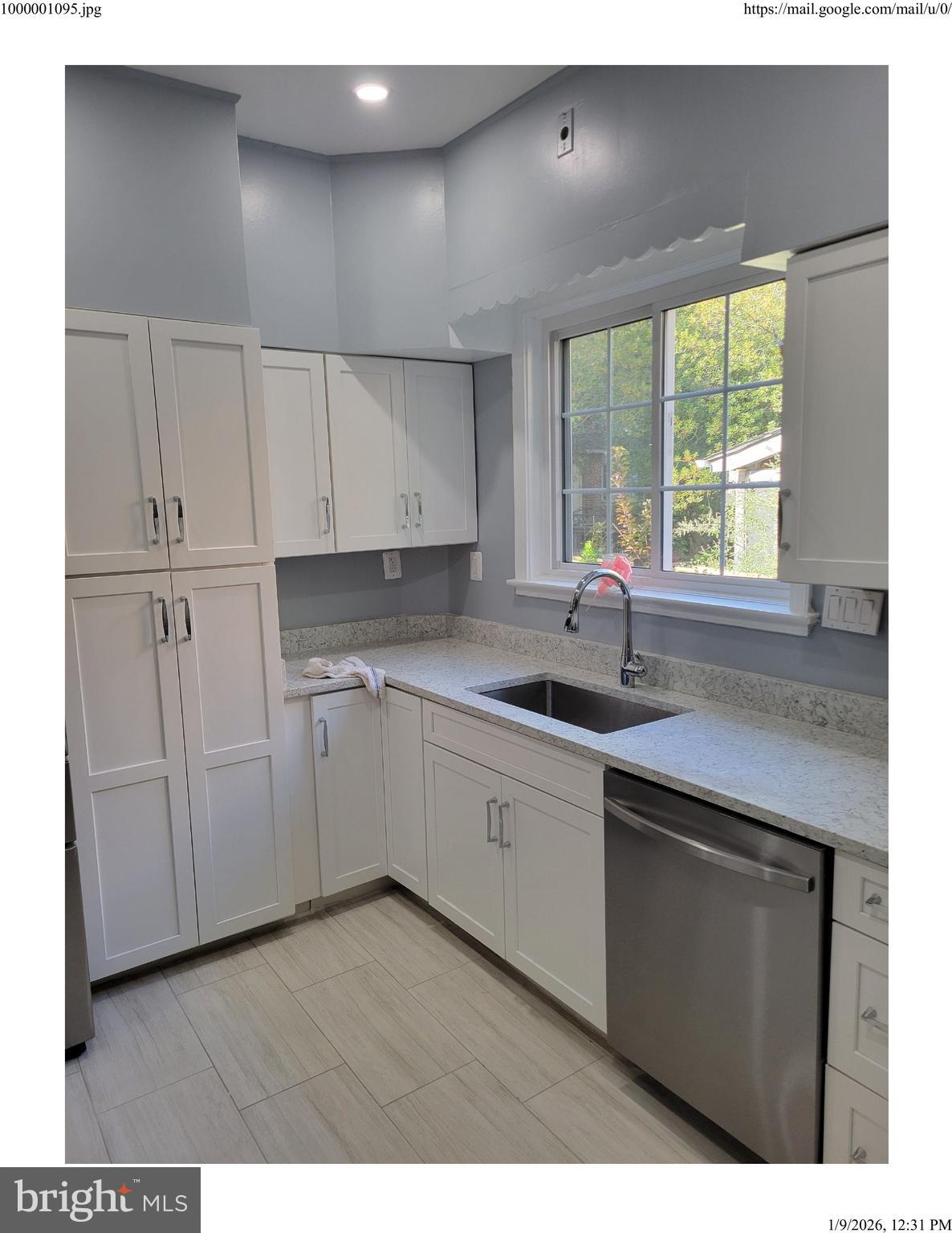 7428 Piney Branch Road Takoma Park, MD 20912 - Photo 7 of 7 a kitchen with cabinets appliances a sink and a window