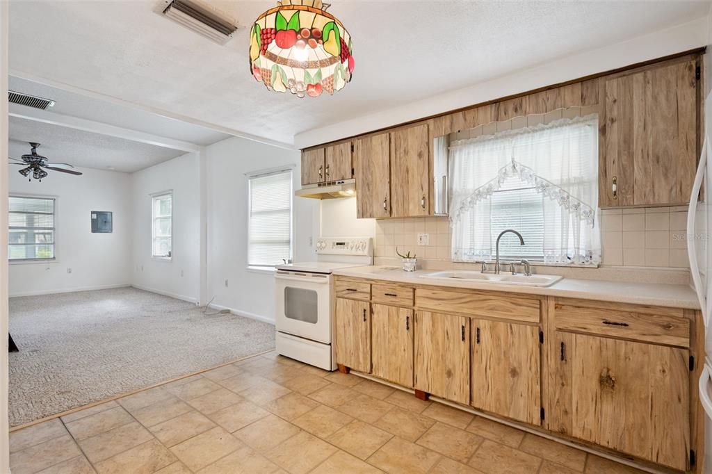 420 Jacks Memorial Road St. Cloud, FL 34769 - Photo 7 of 31 a kitchen with granite countertop white cabinets and window