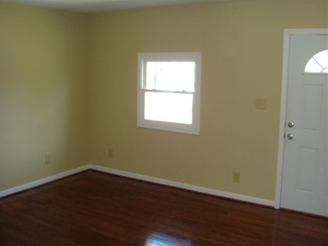 5111 Lewis Road Roanoke, VA 24014 - Photo 2 of 12 an empty room with wooden floor and windows