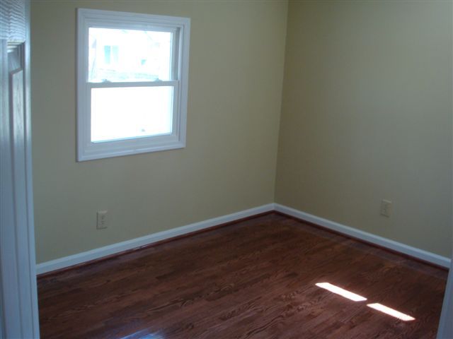 5111 Lewis Road Roanoke, VA 24014 - Photo 6 of 12 an empty room with wooden floor and windows