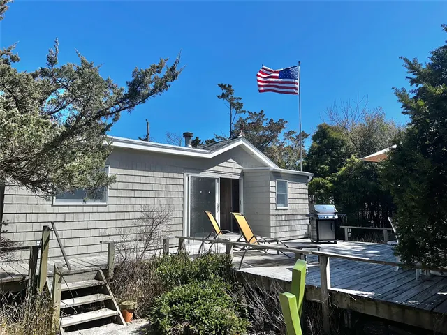 a view of house with a chairs in patio