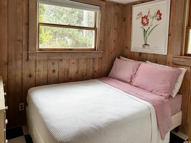 a bedroom with a bed and a window