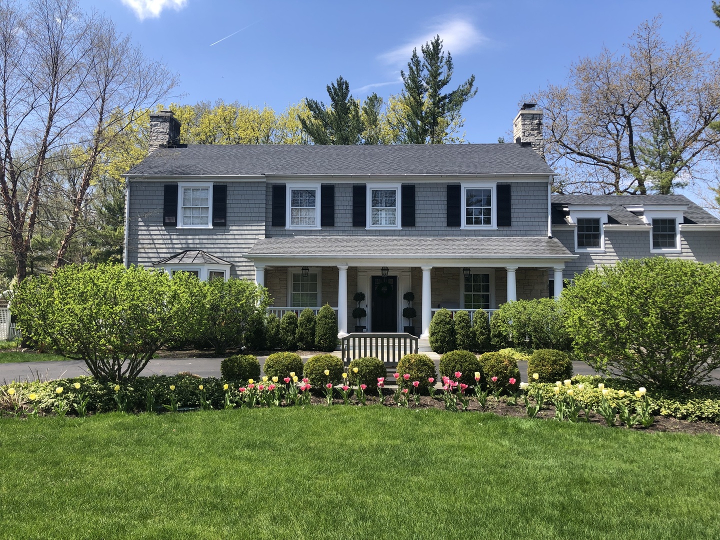 Undisclosed Address Winnetka, IL 60093 - Photo 2 of 38 a front view of a house with a garden and porch