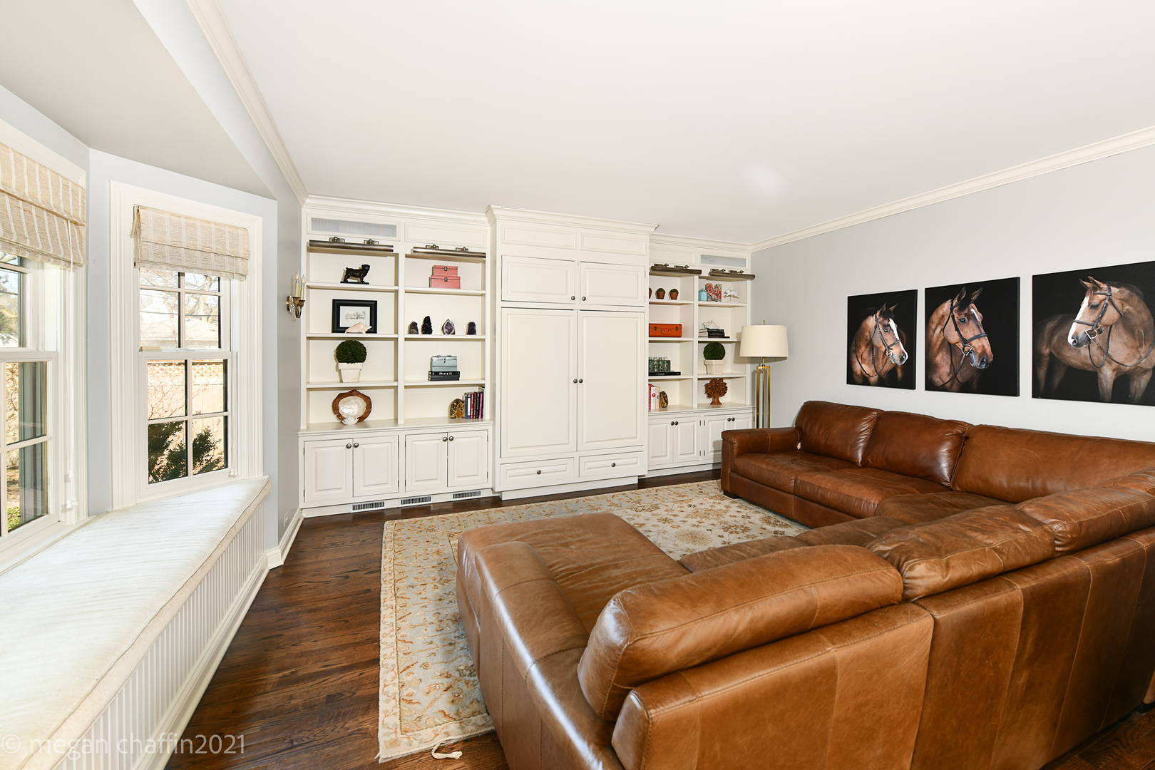 Undisclosed Address Winnetka, IL 60093 - Photo 19 of 38 a living room with a couch and a bookshelf with wooden floor
