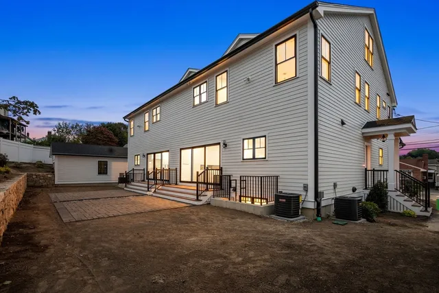a view of a house with backyard and porch