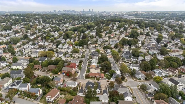 an aerial view of residential houses with city view