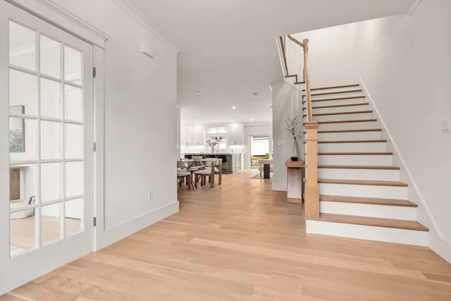a view of entryway and hall with wooden floor