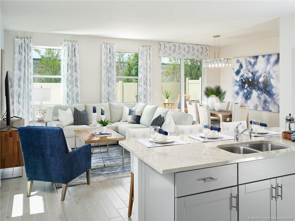 5630 Southeast Edgewater Circle Stuart, FL 34997 - Photo 4 of 9 a living room with furniture and a large window