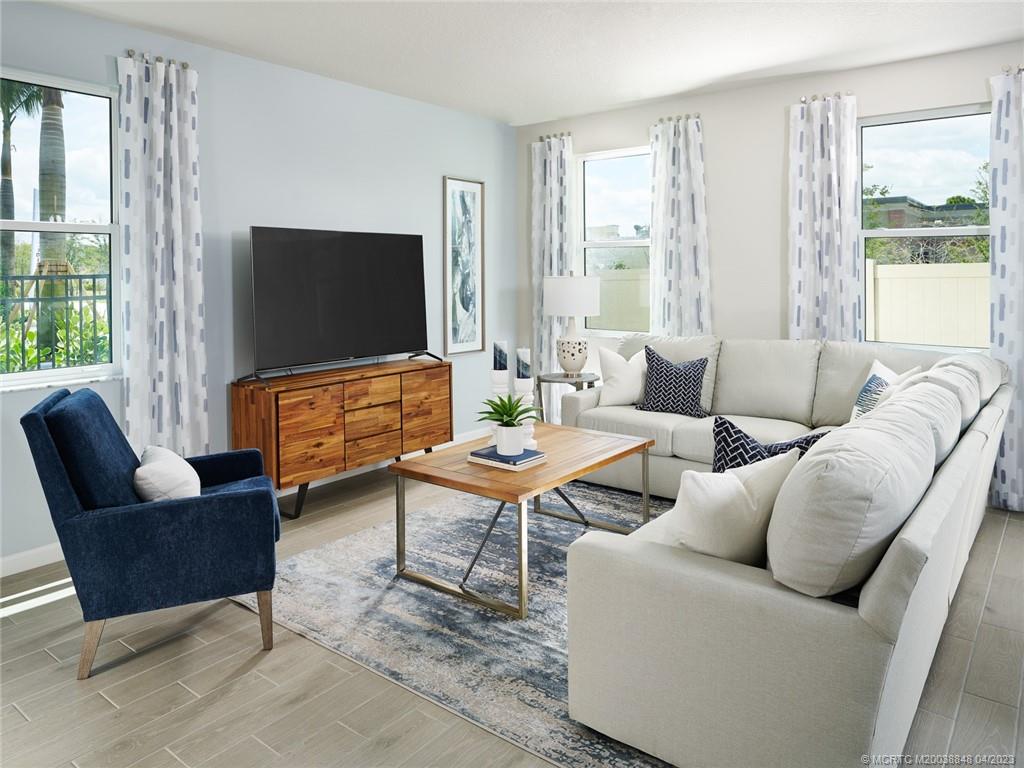 5630 Southeast Edgewater Circle Stuart, FL 34997 - Photo 6 of 9 a living room with furniture and a flat screen tv