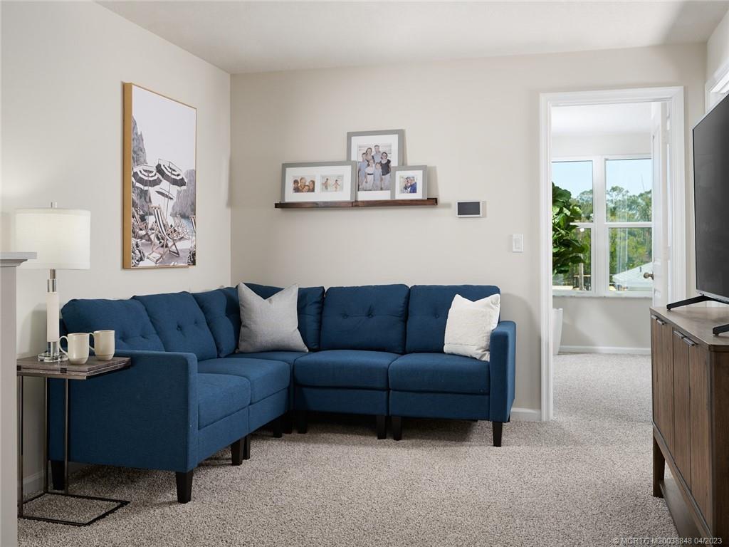 5630 Southeast Edgewater Circle Stuart, FL 34997 - Photo 7 of 9 a living room with furniture and a window