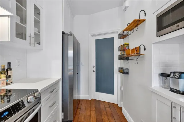 a kitchen with stainless steel appliances a stove and a refrigerator