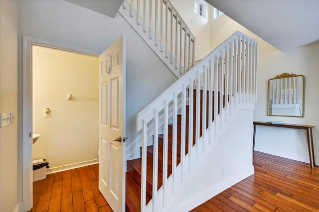 a view of staircase with wooden floor and a large window